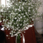 White pew floral arrangement supplied by Creative Floral Designs