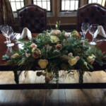 Long and low floral arrangement supplied by Creative Floral Designs