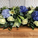 Hydrangea and Delphinium coffin spray by Creative Floral Designs