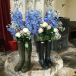 Blue delphinium and rose display supplied by Creative Floral Designs